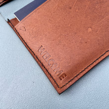 Load image into Gallery viewer, detail image showing welcome emboss in tan kangaroo leather
