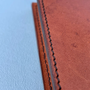 detailed image showing perfect stitching in tan travel wallet